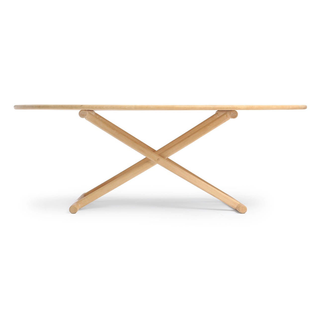 A low table or coffee table in white beech having an exposed X-based structure with sled legs supporting an oval top.