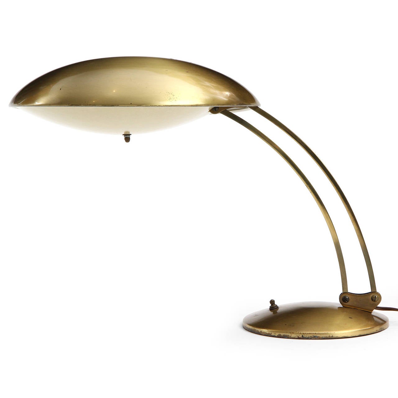 A sculptural and finely crafted adjustable lacquered brass table lamp having  a domed shade with a fiberglass diffuser supported by parallel arching and pivoting arms rising from a weighted disc base.