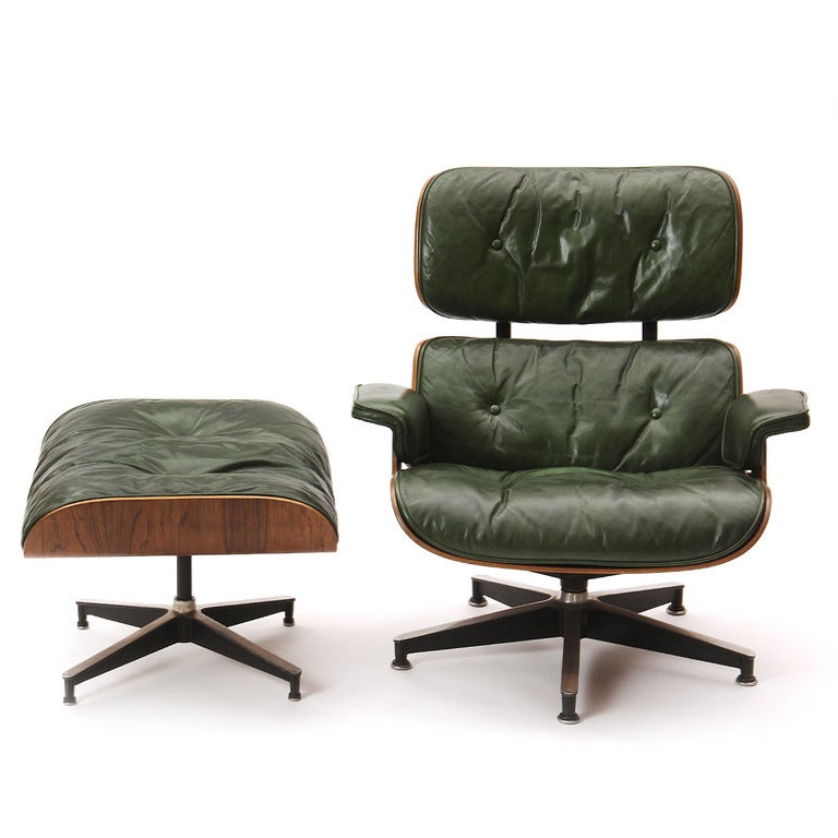 An early edition swivel lounge chair and ottoman with a laminated rosewood shell and green leather on down filled cushions. 

Ottoman: 25.5