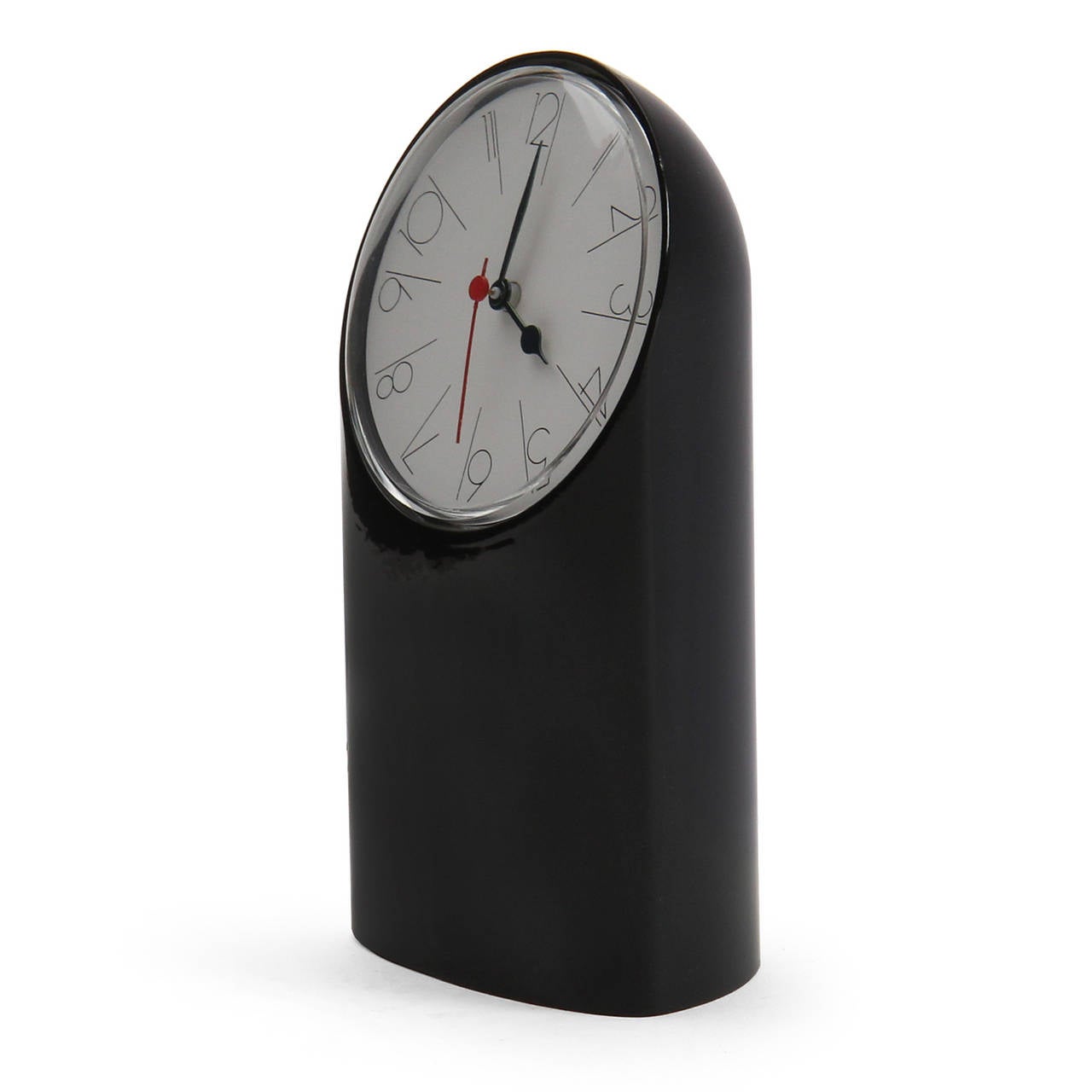 A spare and architectural Tantalo desk clock in lacquered metal having a white circular face with fine black Arabic numerals and a vibrant red second hand.