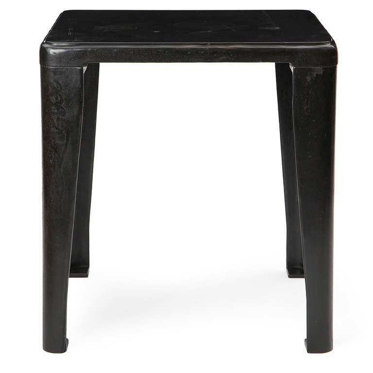 A beautiful, substantial and unusually refined industrial machinist's table in patinated cast iron having a beveled-edge top with rounded corners and v-shaped tapering legs.