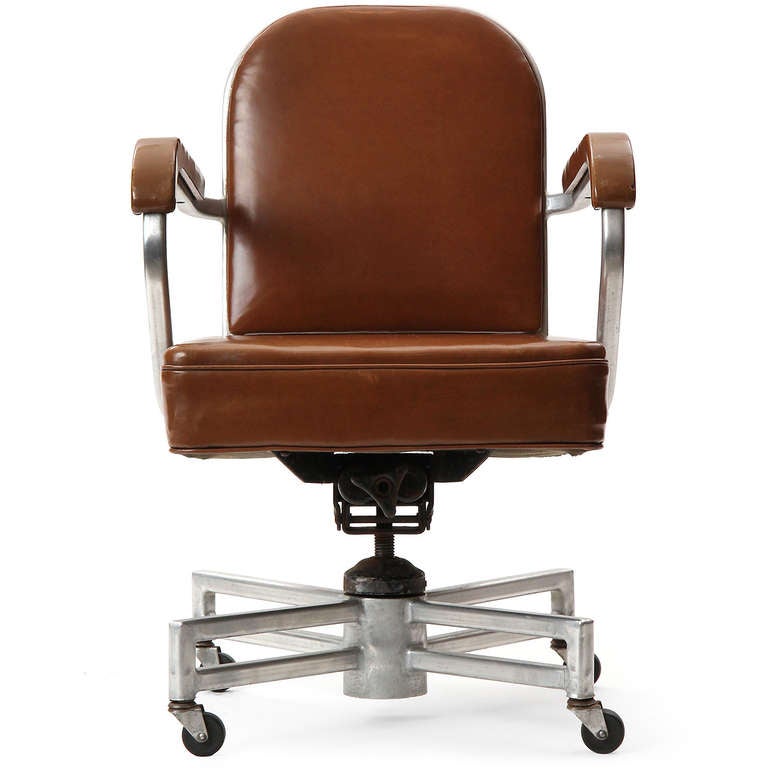 A wonderful aluminum desk chair with a unique double parallel four point base upholstered in brown Nagahyde.