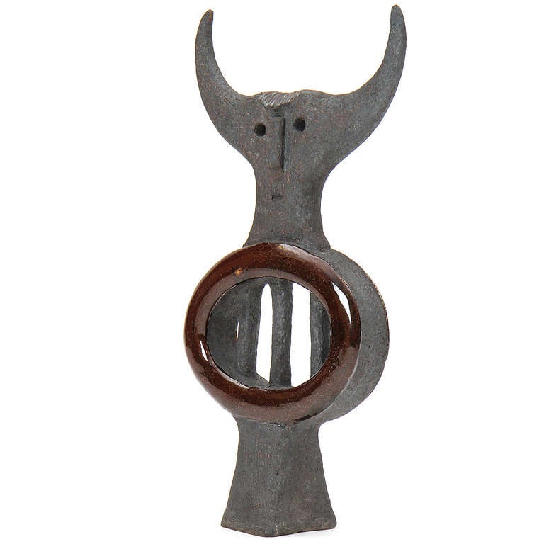 A finely modeled, expressive sculpture with horns, executed in glazed and matte ceramic.