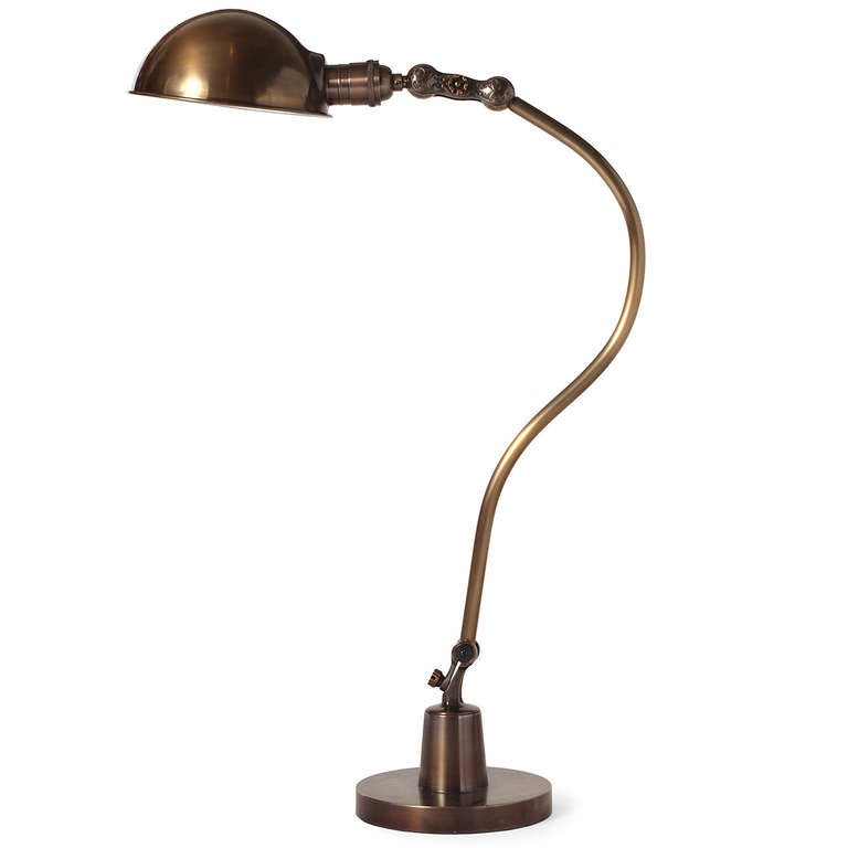 An elegant, beautifully detailed and rare adjusting table lamp in polished and patinated brass and bronze by O.C. White.