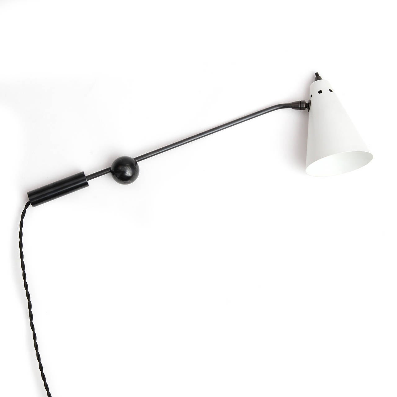 An innovative, uncommon and spare pair of wall lamps having chromed arms with adjustable lacquered conical shades. The arms are attached to circular patinated steel mounting plates by means of a magnetic ball and socket connection, allowing for a