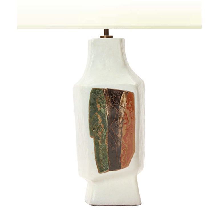 A Mid-Century Modern white ceramic table lamp by Marianna von Allesch featuring two figures etched over green, purple, and orange glaze. Made in the USA, circa 1950s.
Base 17