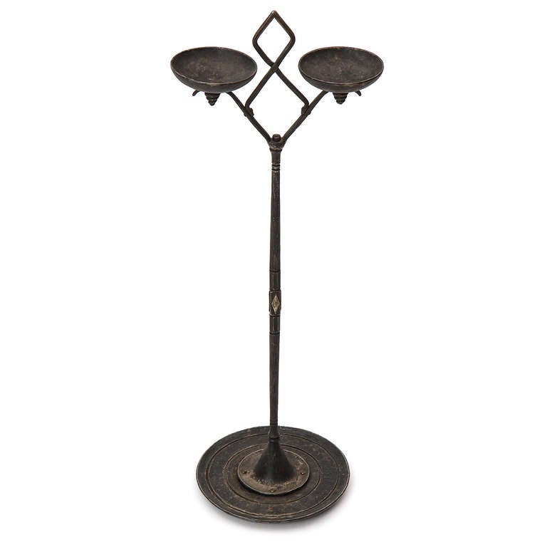 A beautiful stand made of wrought iron and silvered bronze having two bowls branching out from a decorated stem that rises from a stepped dish base. Signed by sculptor Oscar Bach.
