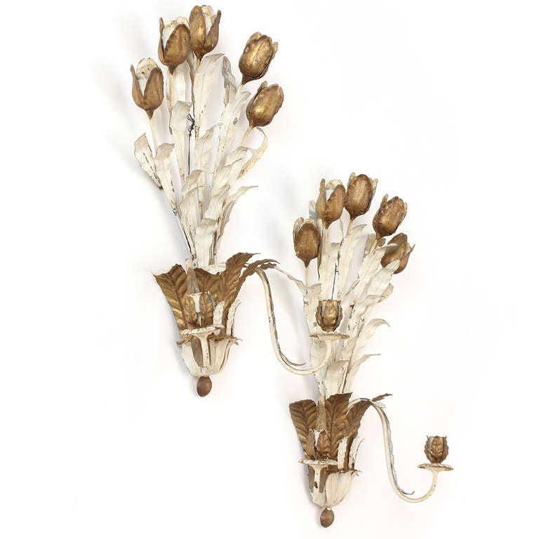 An expressive and masterfully crafted pair of candle sconces depicting tulip stems, realistically handwrought in painted metal.
