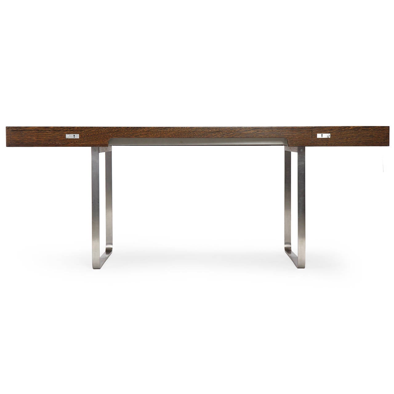An extremely uncommon and sublimely minimalist desk having a rectilinear top of richly figured wenge with two flush-faced drawers floating above spare continuous banded legs of brushed steel.
