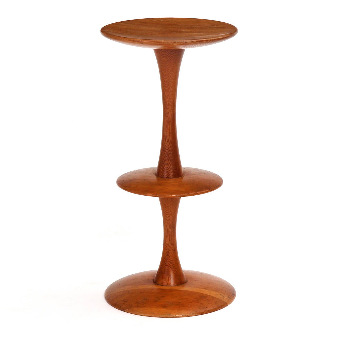 A sculptural, uncommon and beautiful lathe-turned pedestal having an expressive undulating form and crafted of solid teak.