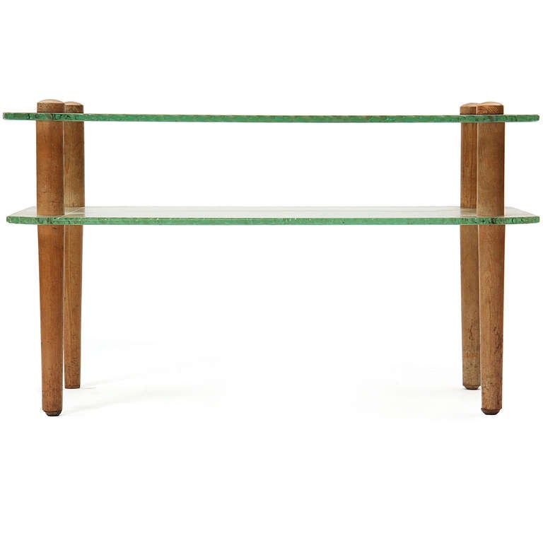 A two-tiered end table with ash dowel legs and thick industrial green-tinted glass having rounded and textured edges. Shelf is 5.75