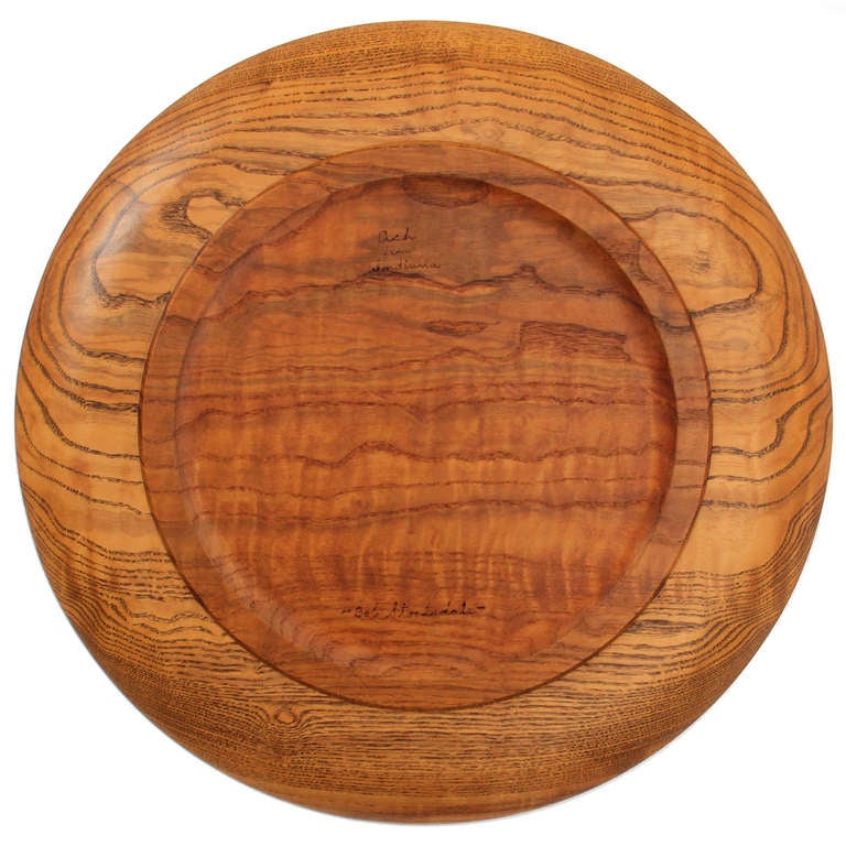 A large signed platter with a lightly raised rim in highly figured Indiana ash by California master woodturner Bob Stocksdale.