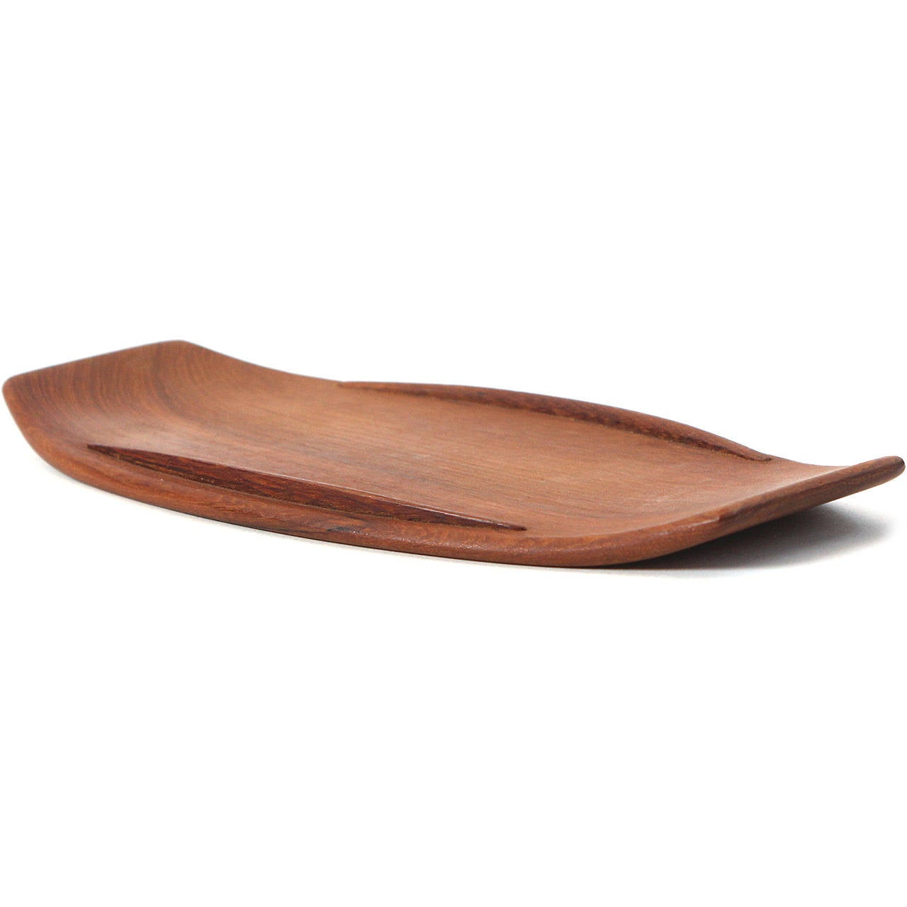 Possibly a unique prototype, this oblong railed tray with upturned ends beautifully crafted of warm-toned solid teak is half the size of the later staved production version produced by Dansk.