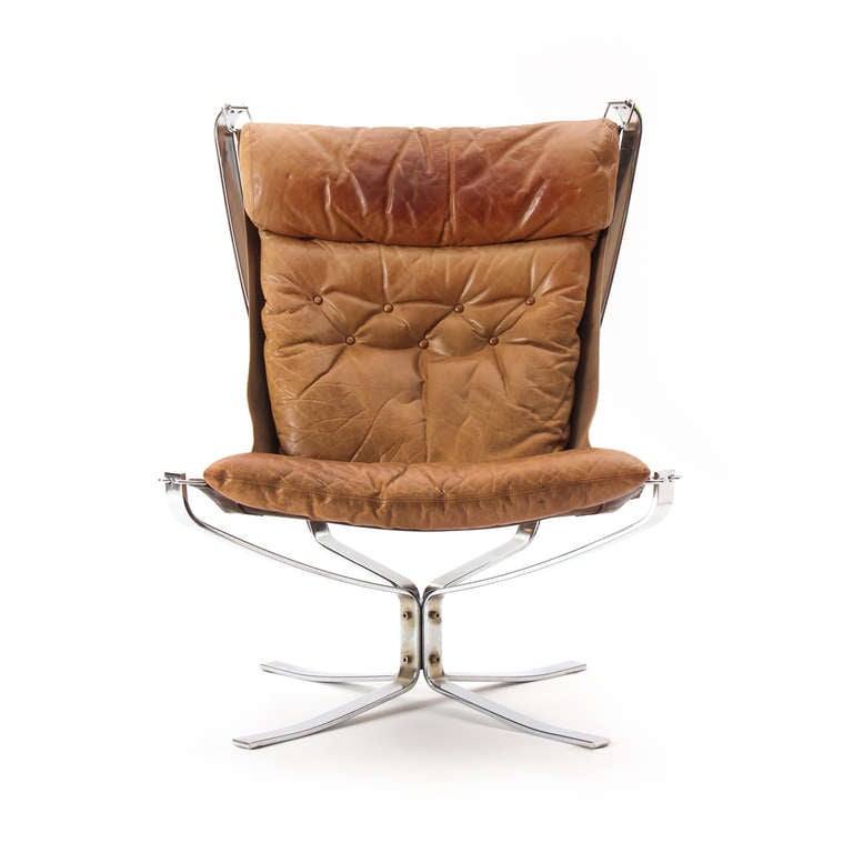 The Falcon easy chair In steel with a suspended tufted leather seat. A pair is available.