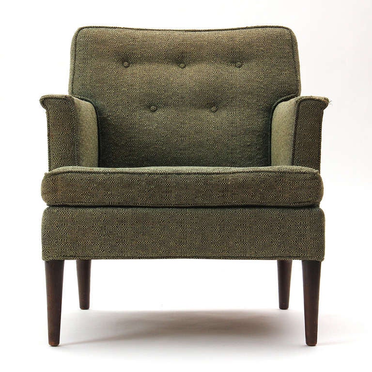 A button-tufted and tailored armchair with a saber leg detail by Dunbar that retains its original wool upholstery.