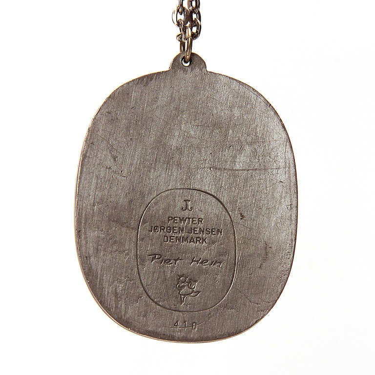A pendant in pewter by the mathemetician and designer Piet Hein, having its original chain. Signed and made by Jorgen Jensen, Denmark.