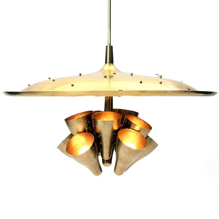 Spectacular and rare chandelier in lacquered brass having ten perforated up lamps and an embossed dome with modernist flora and fauna and faceted crystal detail. Designed by Paavo Tynell for Taito Oy, Finland.