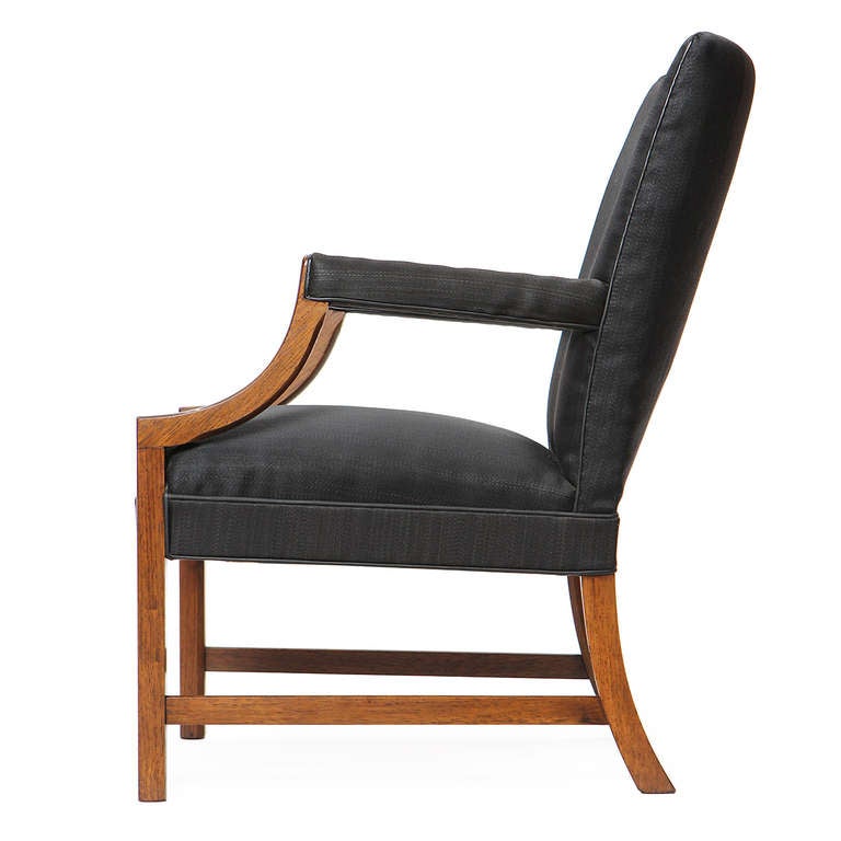 A stately and elegant modern Chippendale-influenced armchair finely crafted in mahogany with original horsehair upholstery with leather welting.