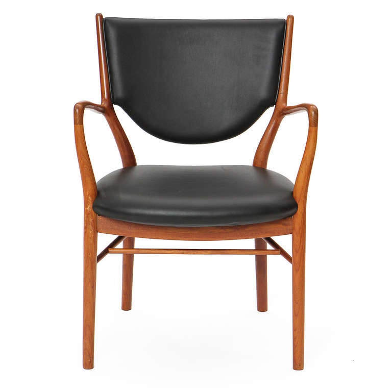 A fine pair of uncommon and sculptural early production NV46 armchairs in teak and leather.