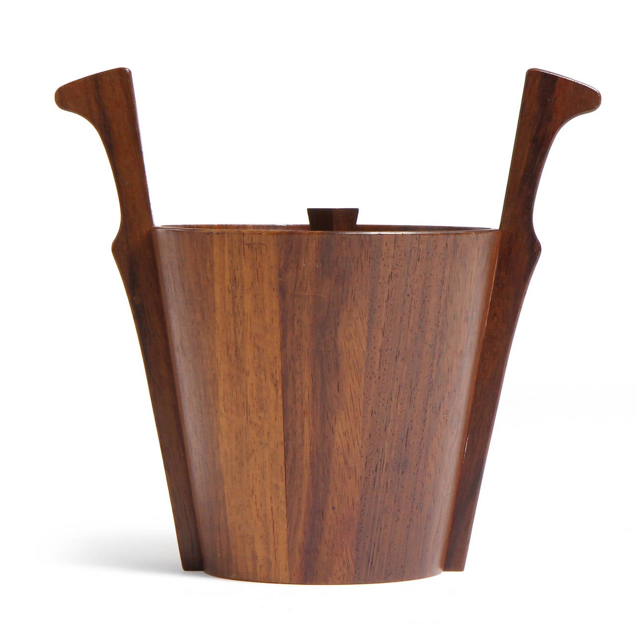 A dramatic and well-scaled conical ice bucket in rich staved teak having expressive flaring and carved applied handles.