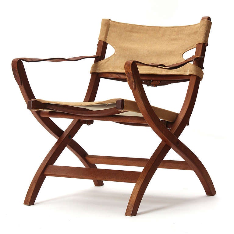 A folding campaign chair in teak, leather and canvas in fine, original condition.