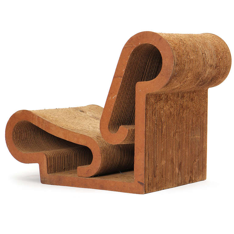 A dramatic and early armless lounge chair of scrolling form crafted from corrugated cardboard and masonite and designed by Frank Gehry as part of his seminal Easy Edges collection.