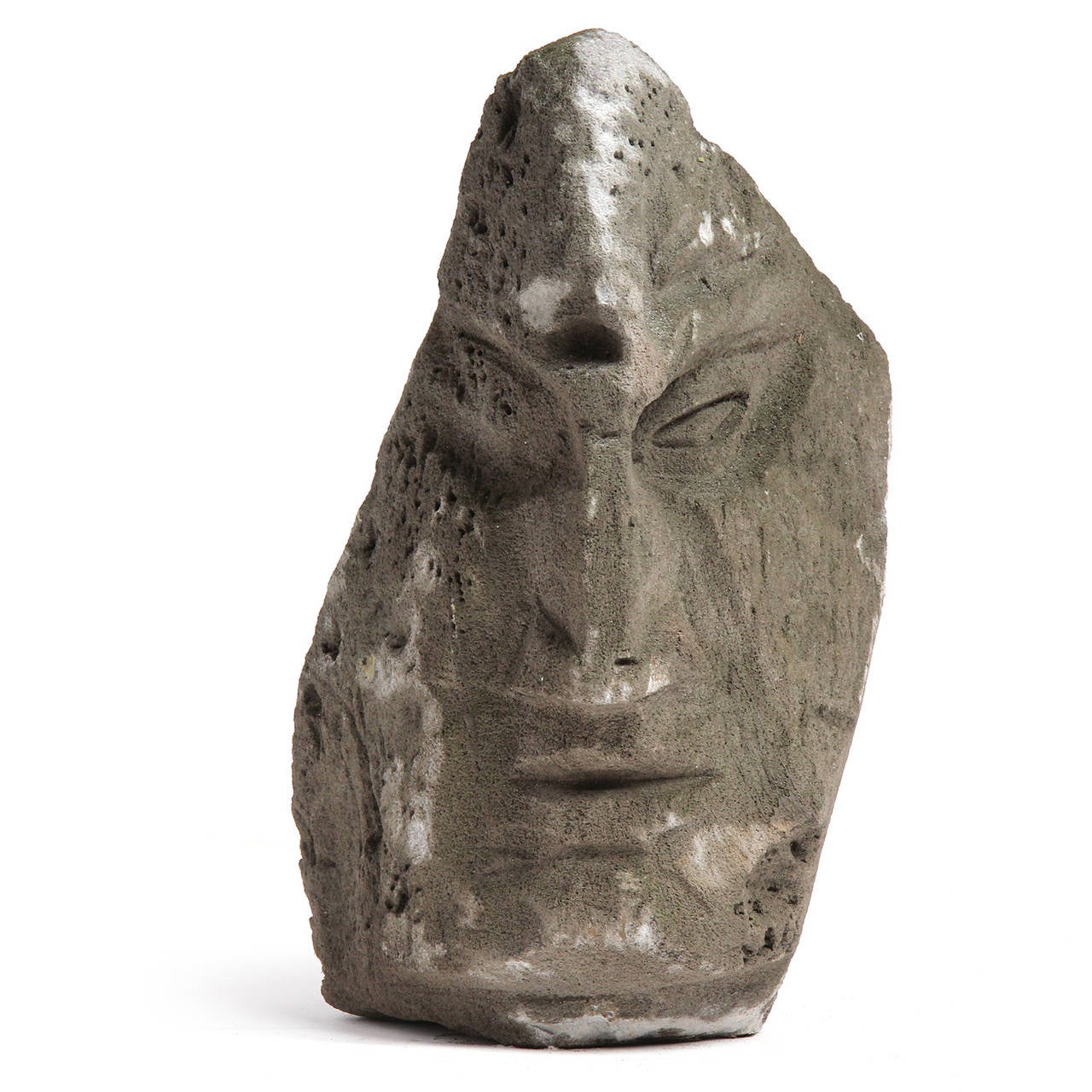 An abstracted sculpture of a face, finely carved in earth toned volcanic stone. Signed by the artist.