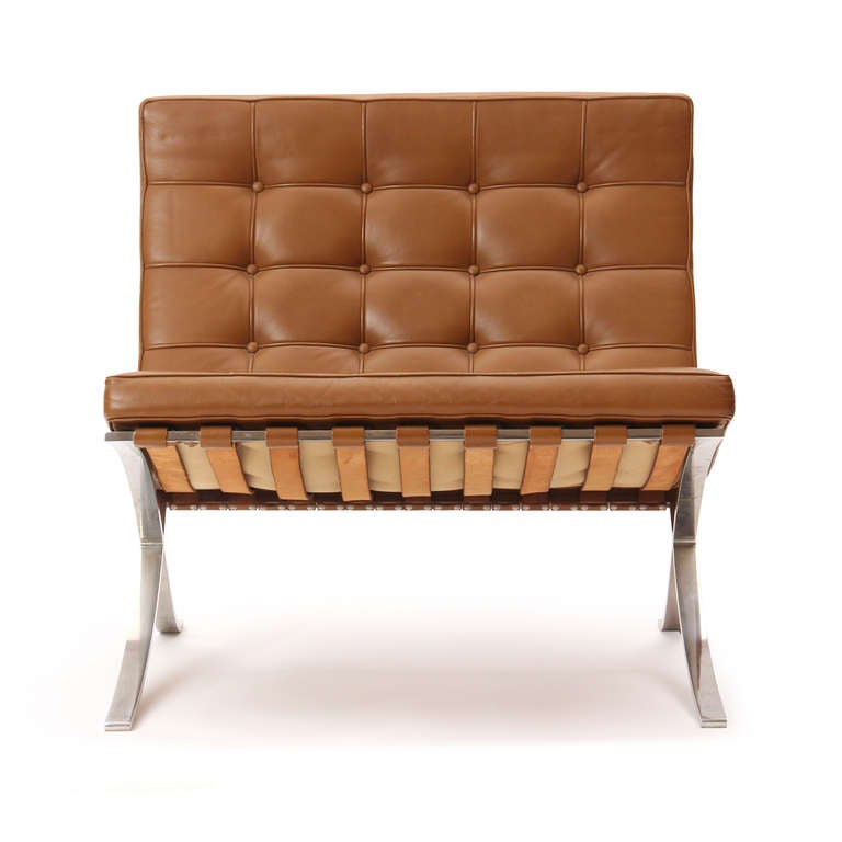 Originally designed for the German Pavilion of the 1929 Barcelona International Exposition, this example is from Knoll and retains its original button-tufted leather upholstery floating in a highly polished steel frame. By Knoll Associates.

- 2x