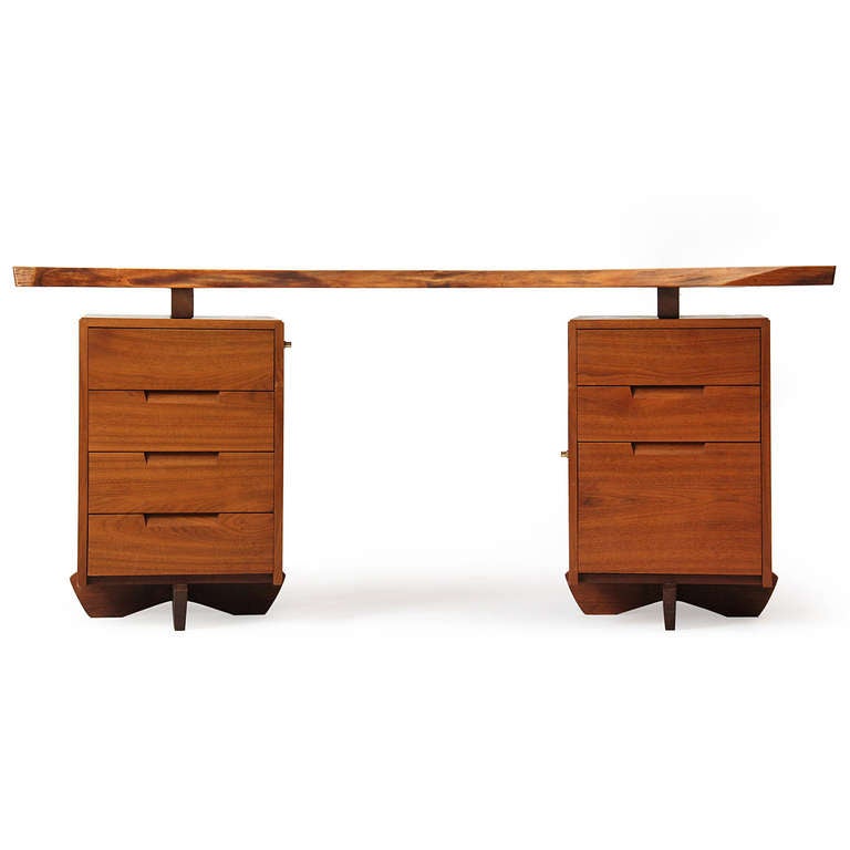 An outstanding and rare double pedestal desk in walnut by George Nakashima with a highly expressive floating and overhanging single-slab free edge walnut top with two rosewood butterflies.