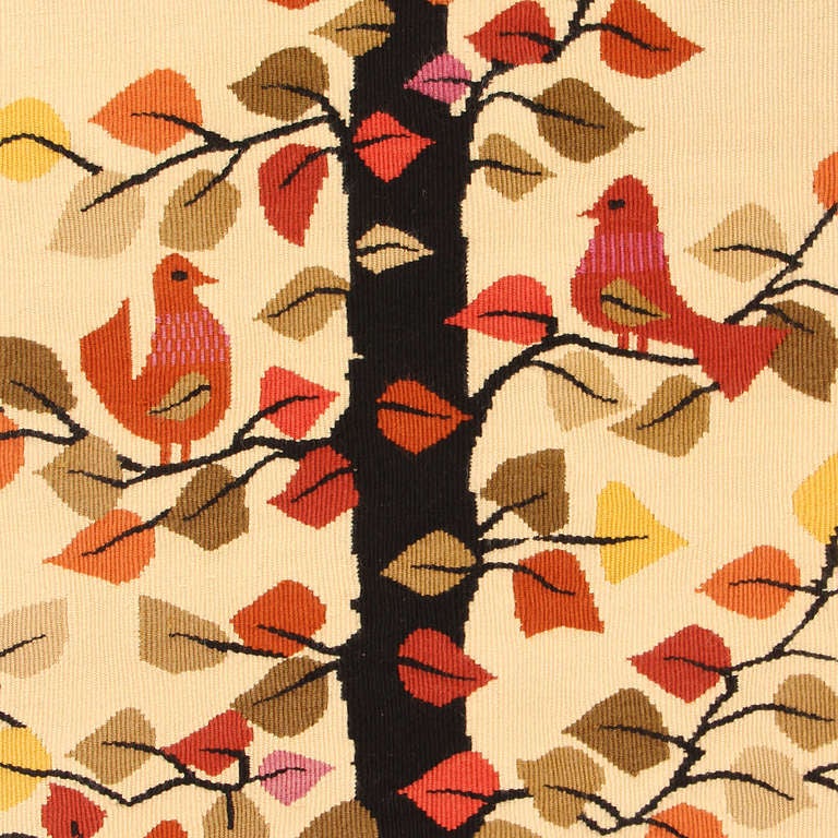A graphic weaving of a tree in autumn foliage and birds.