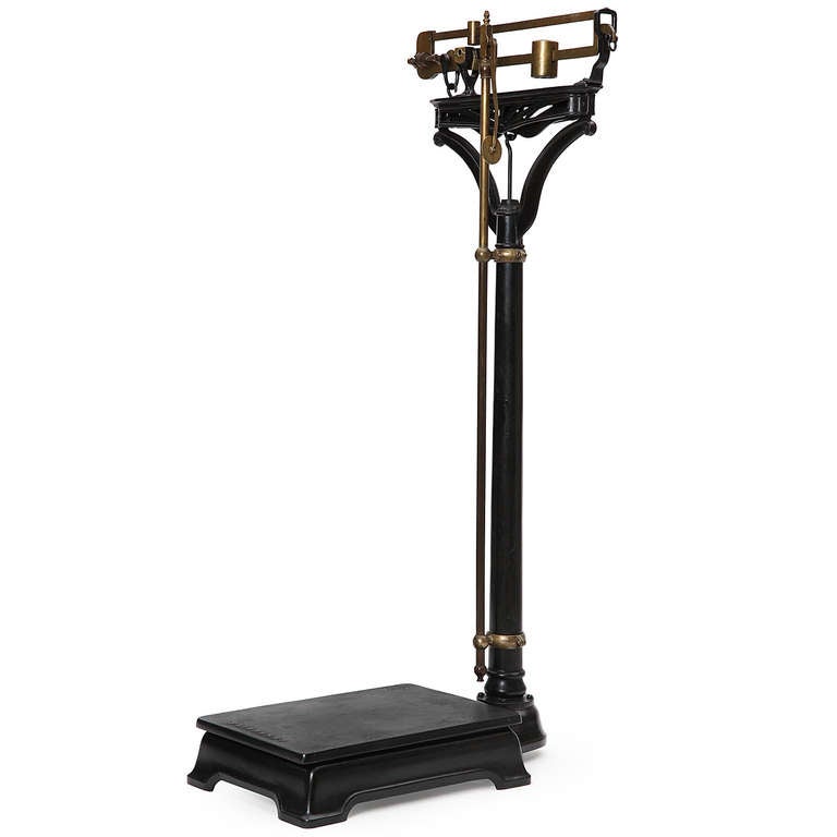 A superb doctor's scale of the highest quality having a patinated cast iron body (retaining its original retractible brass height measurement bar) and a precisely machined weight carriage with all the original brass weights in place. This scale is