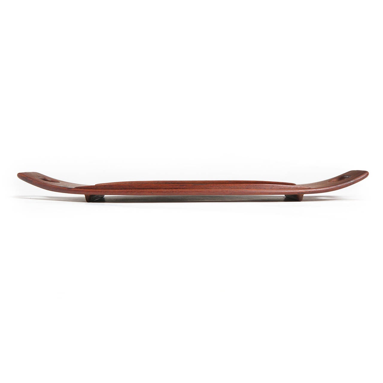 A finely crafted, elegant and uncommon railed serving tray of oblong form with upturned ends and cut out handles made from staved planks of rosewood.