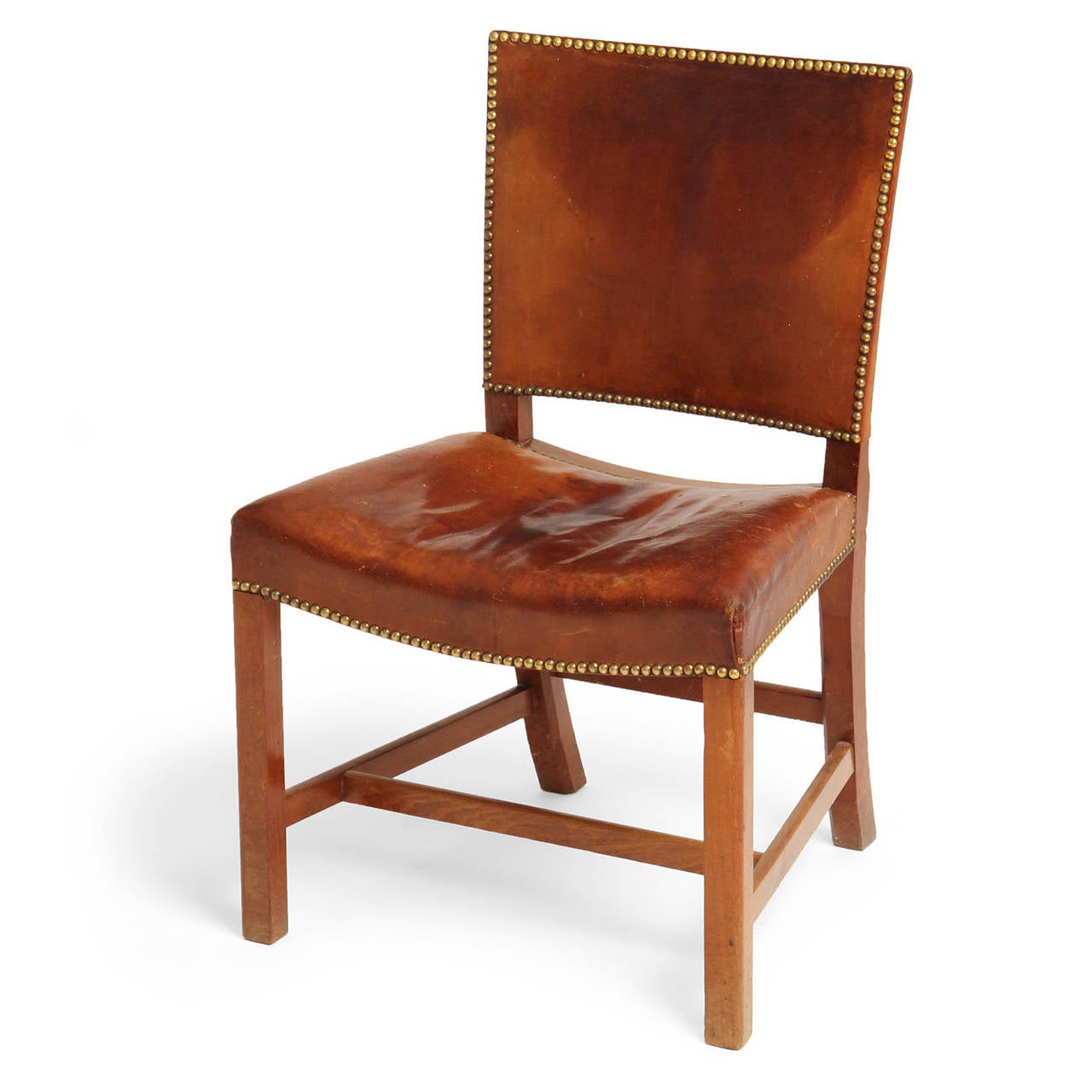 A Cuban mahogany 'Barcelona' dining chair designed by Kaare Klint featuring the original natural leather upholstery. Originally introduced at the 1929 International Exposition in Barcelona, Spain. Made by Rud Rasmussen in Denmark, circa 1930s.