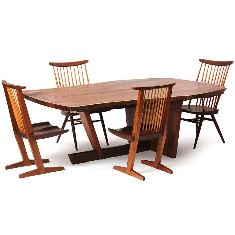 A magnificent free-edge studio dining table having a top of book matched and highly figured walnut slabs joined with four rosewood butterfly splines. Chairs available separately.