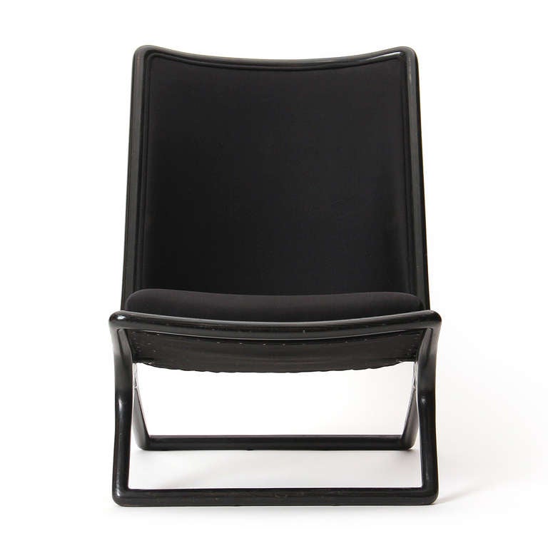 A dramatic (and comfortable) high-back scissor-legged slipper chair with black ebonized ash frame and black upholstery.