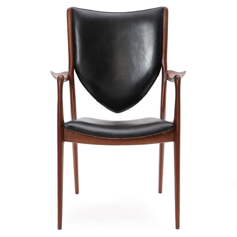 An excellent set of Shield Back dining chairs having sculptural carved walnut frames and fine black leather upholstery. This set is comprised of eight side and two armchairs.

Side chair is 19