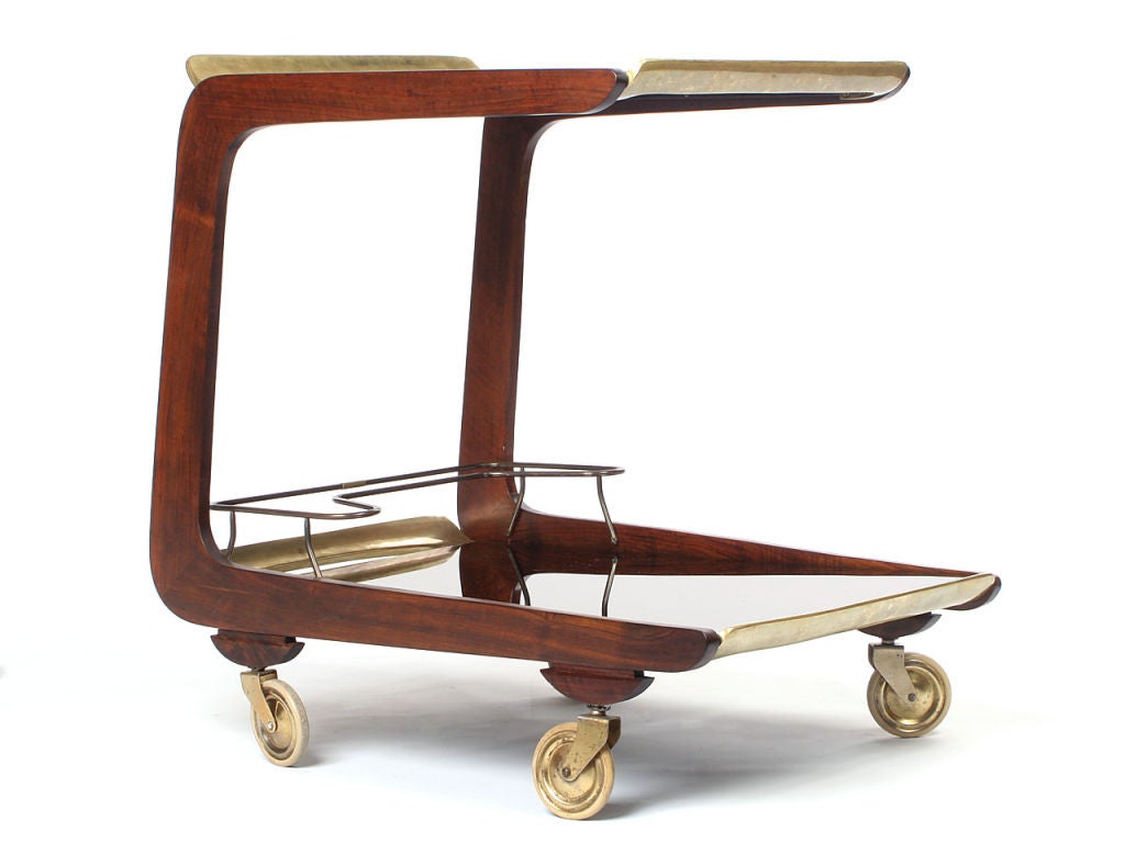 A two-tiered cart in solid walnut with brass details and wheels. Design by Carl Aubock made by Aubock Atelier