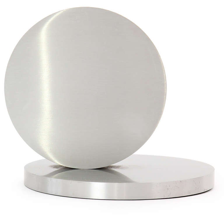 Sculpture minimaliste et finement rendue ayant la forme de disques d'aluminium poli entrecroisés et usinés avec précision.