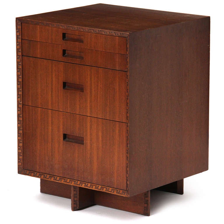 A pair of uncommon night stands in solid mahogany from Frank Lloyd Wright's Taliesin collection for Heritage-Henredon, having four drawers over a cruciform base and Greek key perimeter detail.