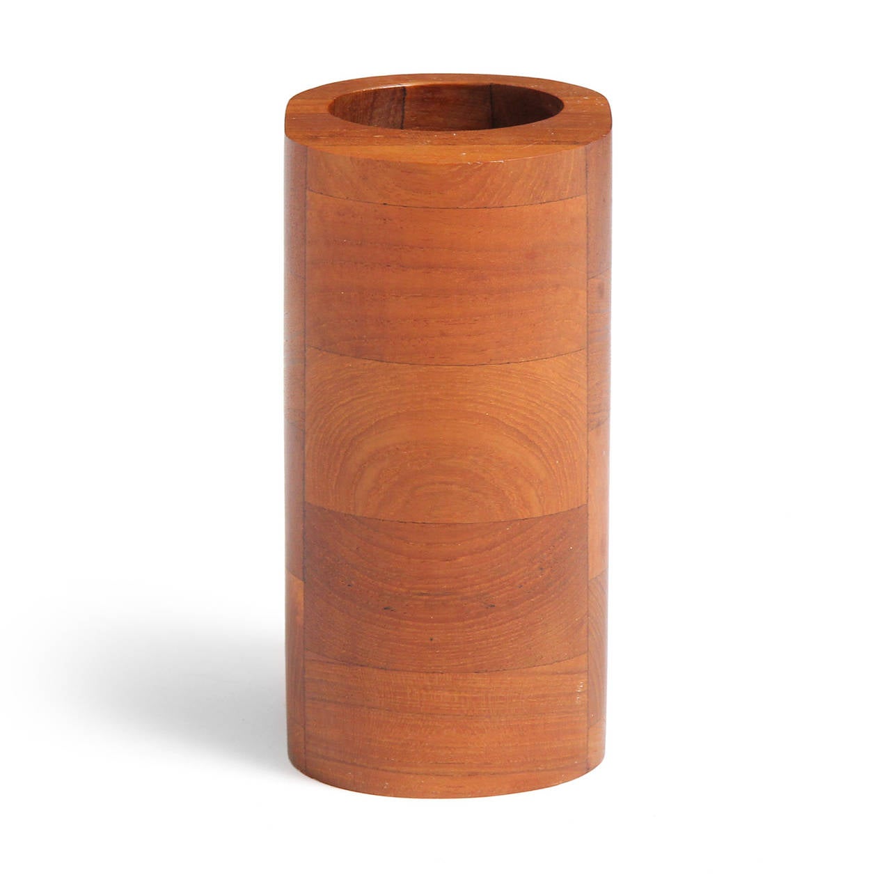 An unusual and sculptural oval vase with a circular opening, masterfully crafted of stacked solid teak.