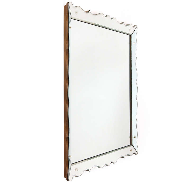 A Venetian-style wall mirror with scalloped & beveled frame.
