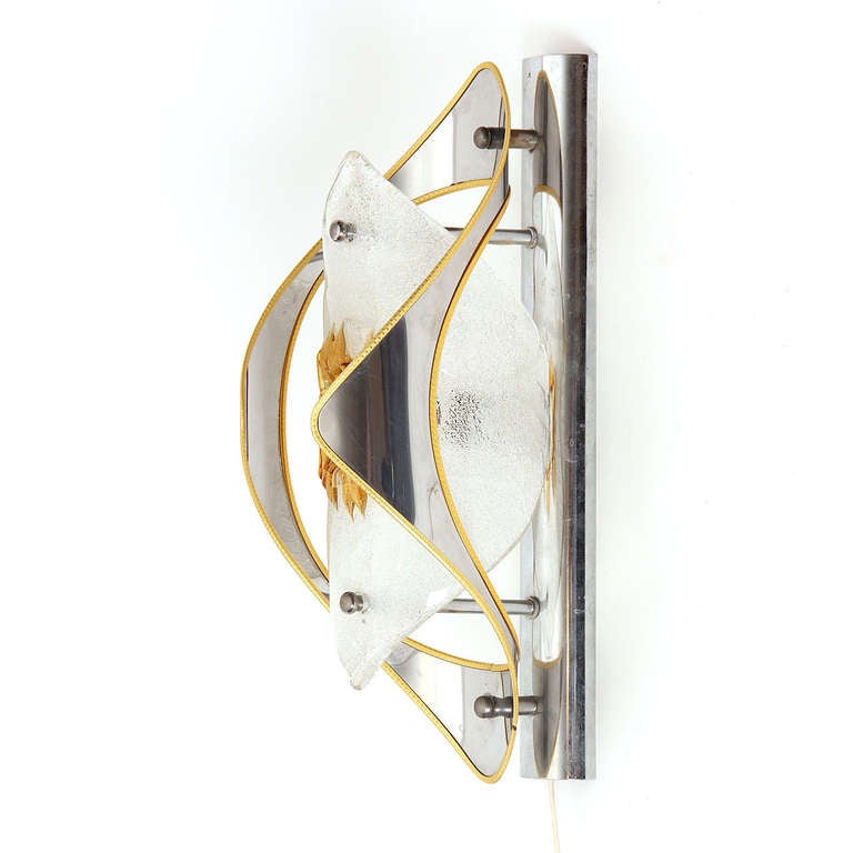 A pair of expressive sconces made from hand blown and worked glass elements wrapped in brass edged chromed steel open columns.