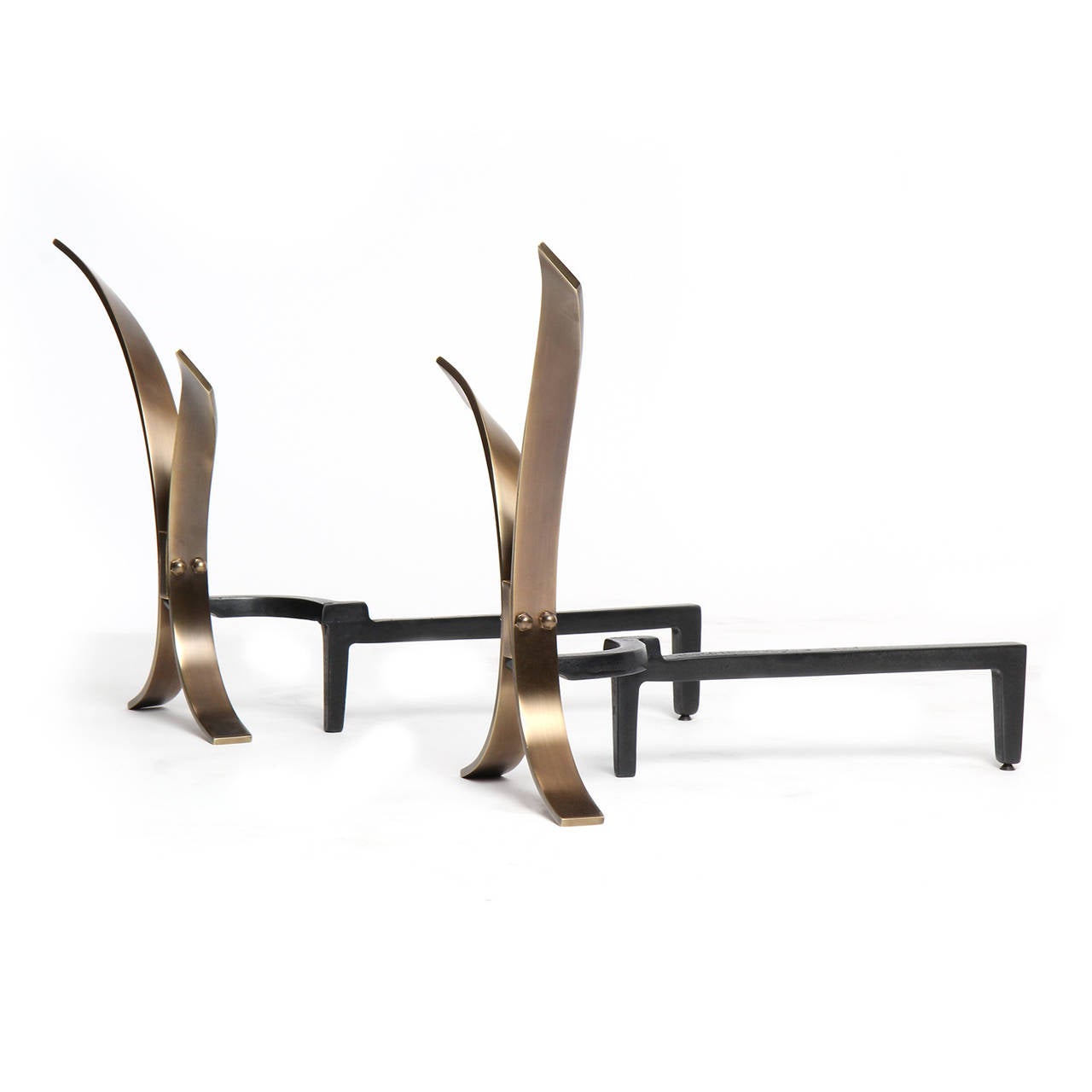 A sculptural and expressive pair of midcentury polished bronze andirons fashioned from conjoined flaring and twisting narrow planes of bronze attached to a blackened iron base. Made in the USA, circa 1950s.