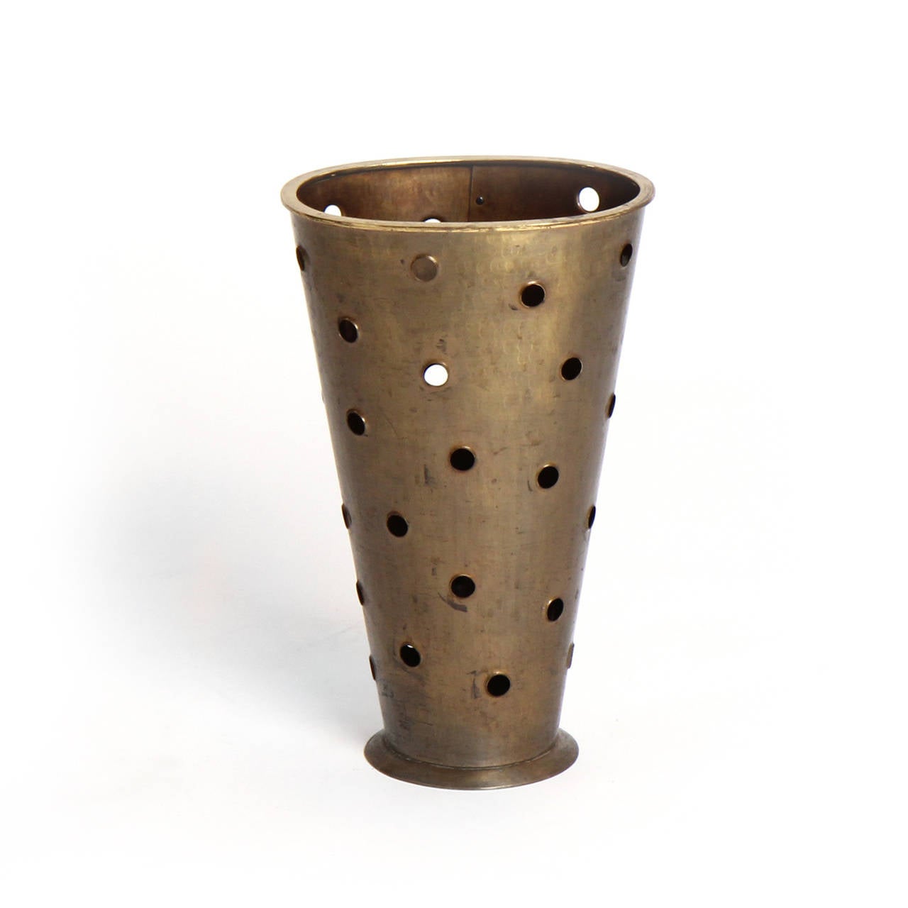 A superbly handcrafted footed cane / umbrella stand of oval form, fashioned from a single hammered and riveted sheet of patinated bronze, with perfectly executed perforations.