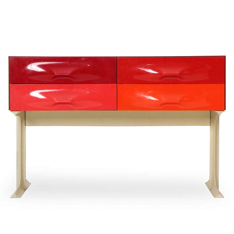 A sculptural and striking four drawers chest with vivid orange to red drawer fronts that float over unique I-beam legs.