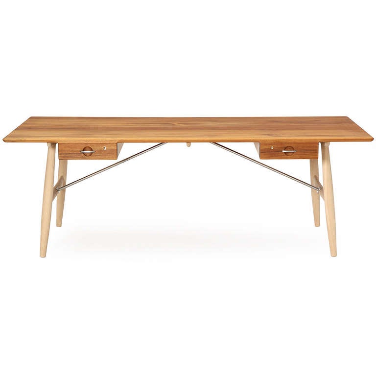Wegner's iconic Architect's desk with a solid oak top over two floating drawers, on splayed oak dowel legs with diagonal, stainless steel rod stretchers.