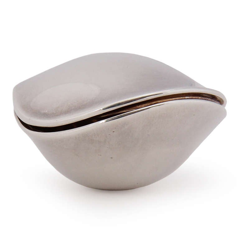 A petite pill box, resembling an oyster, with exquisite design and feel. Made of sterling silver.
Hallmarked by maker and designer.
