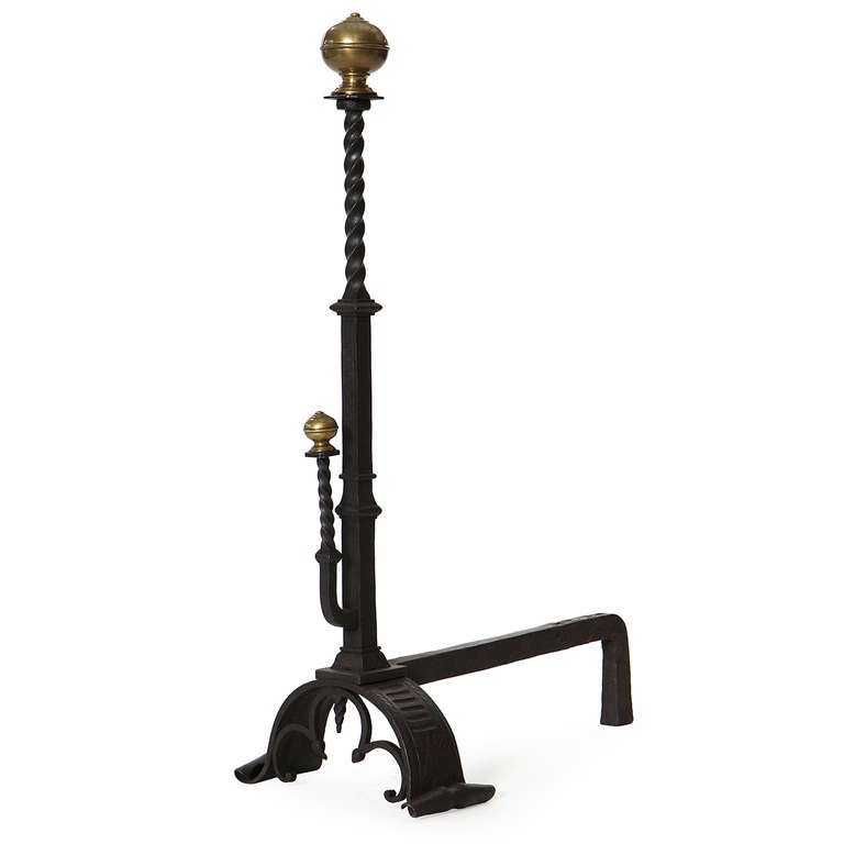 A unique and sculptural set of andirons with hand forged base, wrought iron risers and bronze orb shaped finials.