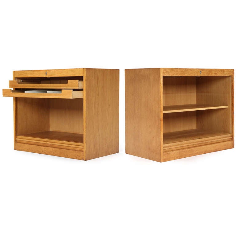 An oak cabinet with a drop down tambour door concealing letter trays, filing compartment and shelving.