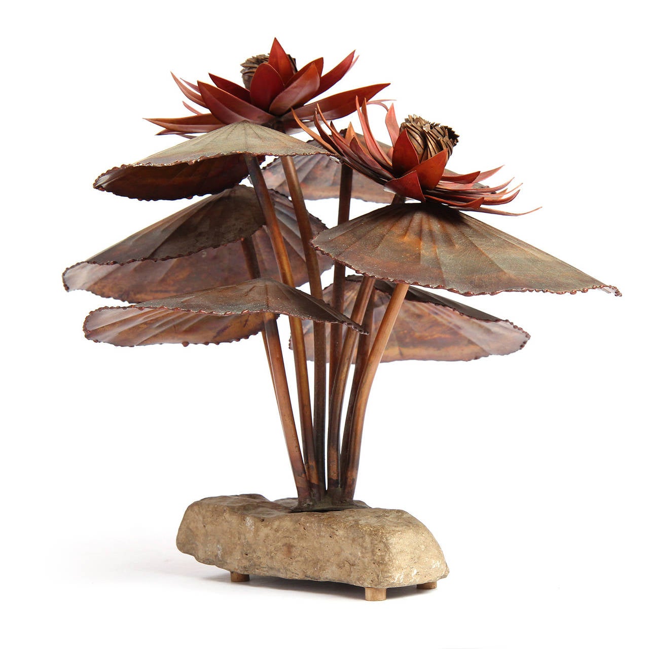 A highly expressive and unique hand made metal sculpture depicting water lilies sprouting from a stone base and having a rich variegated patina.